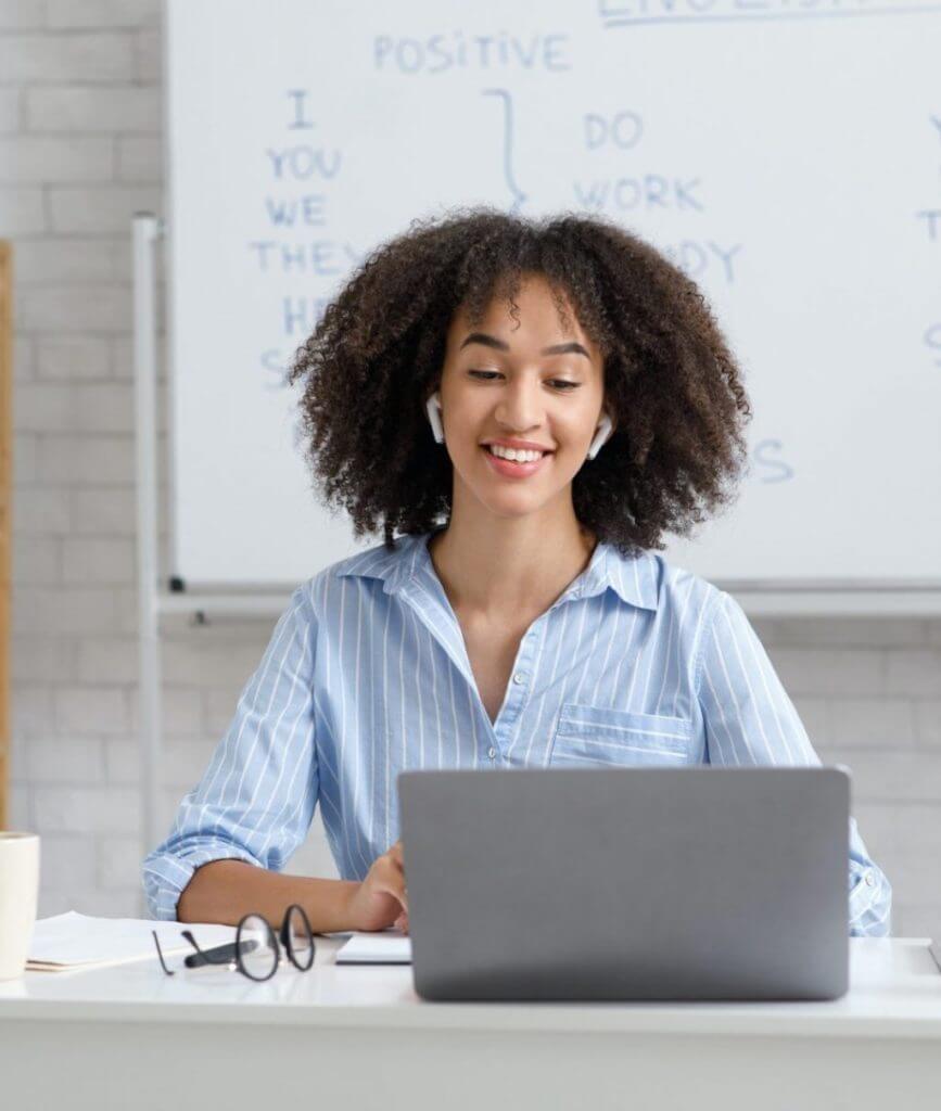 teacher works online during quarantine woman chatting with students at online lesson in living room s